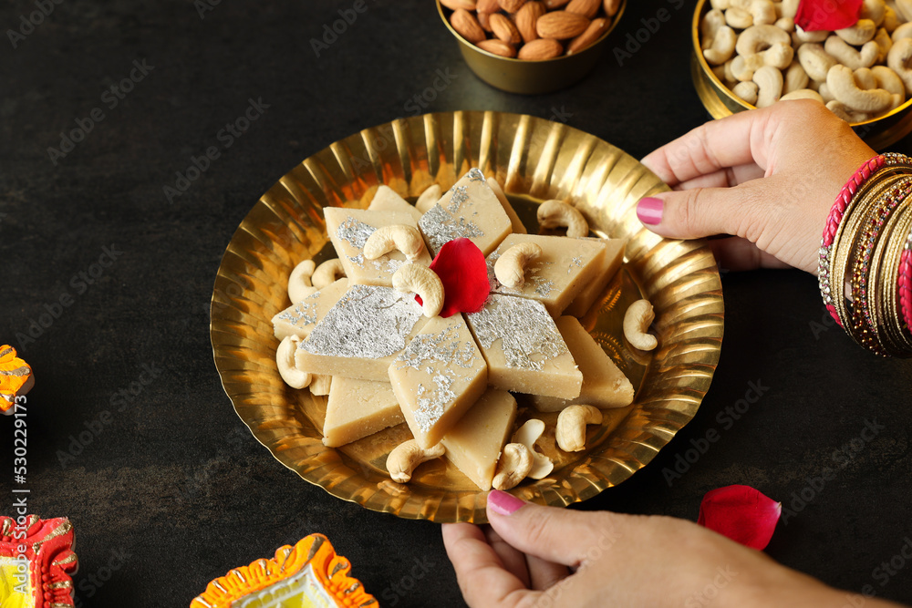 Kaju katli served on a brass plate
