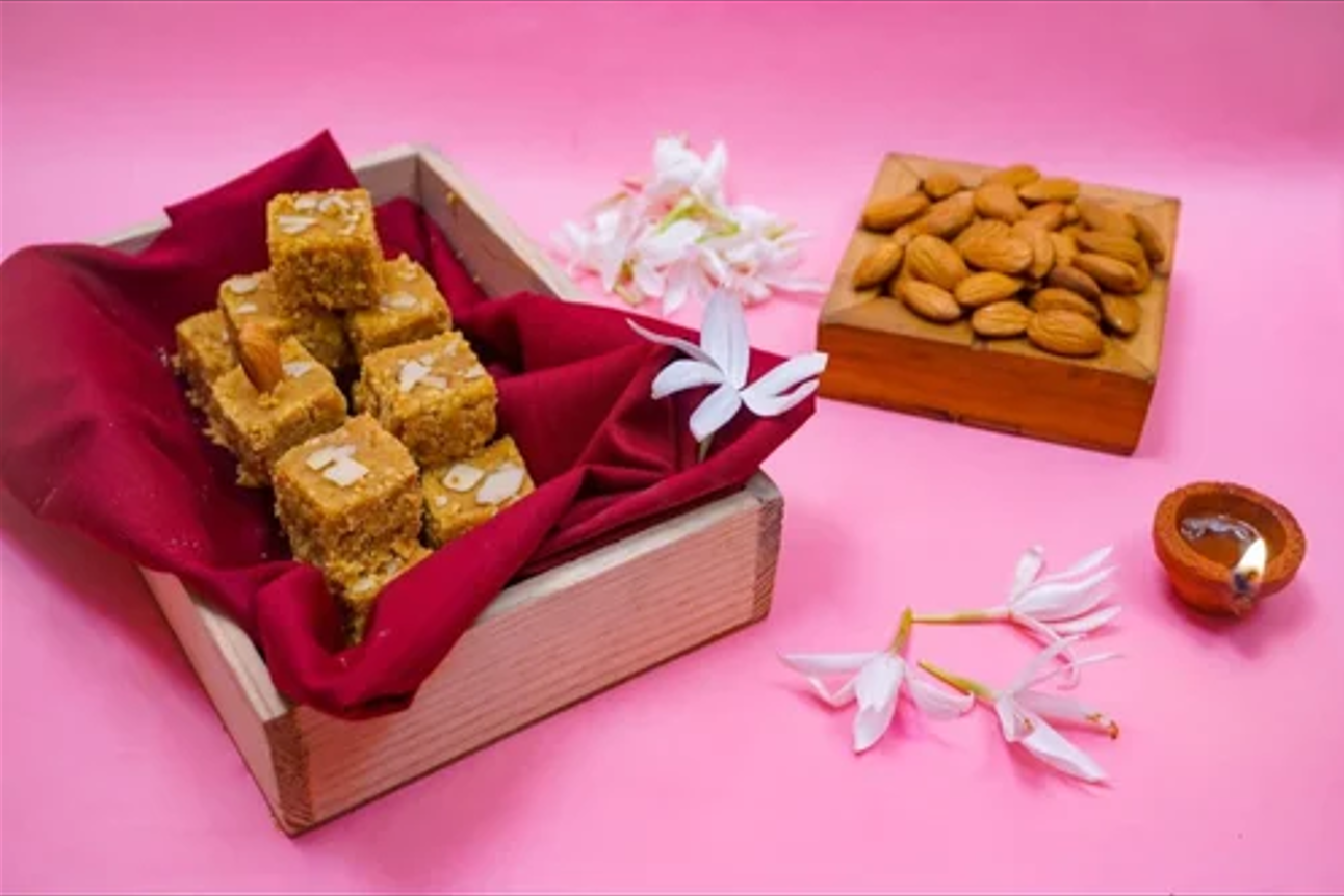 Mohanthal squares arranged inside a gift box