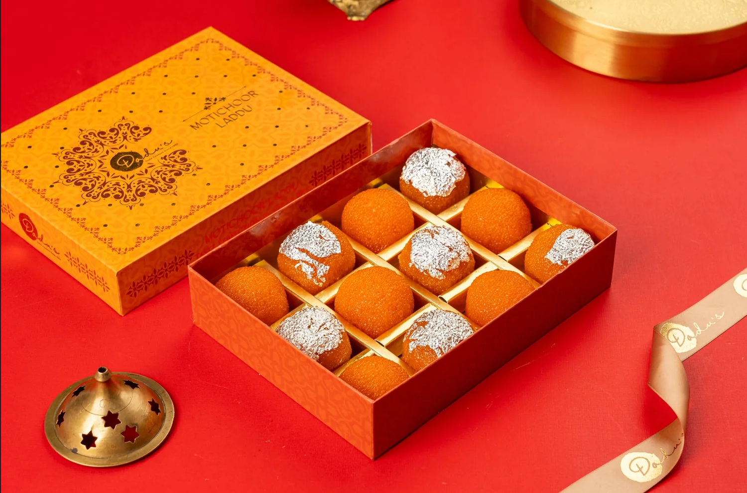 Motichoor ladoos arranged inside a Maharaja House gift box